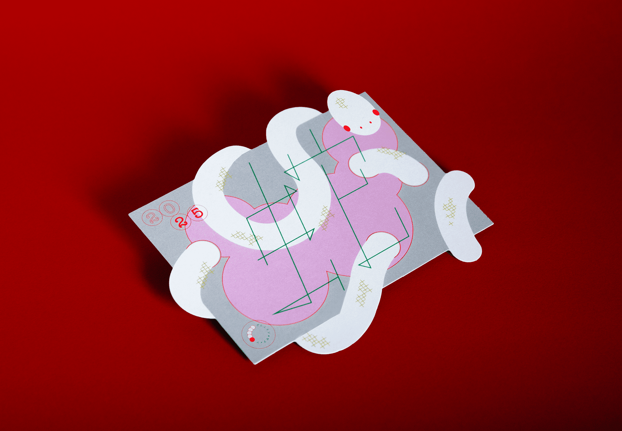 Die-cut greeting card designed by Josephine Grenier, showing the colorful abstract front with a snake for 2025.