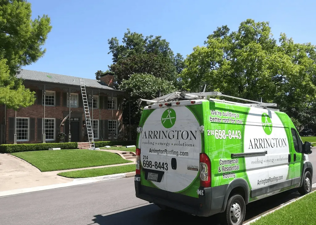 Arrington Roofing van parked in front of a house with ladder on roof
