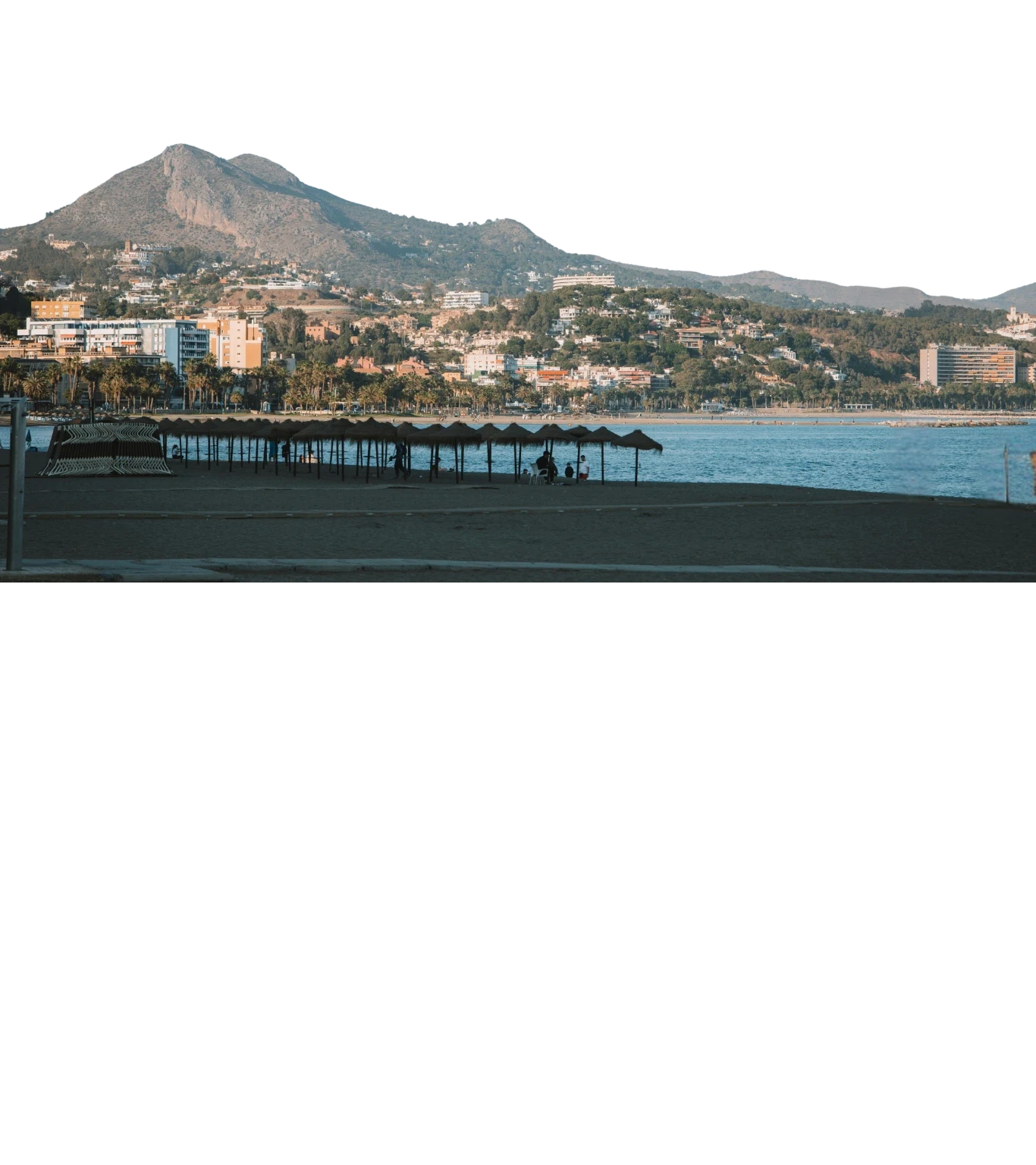 Sandy beach in Málaga with the city skyline and buildings visible in the background