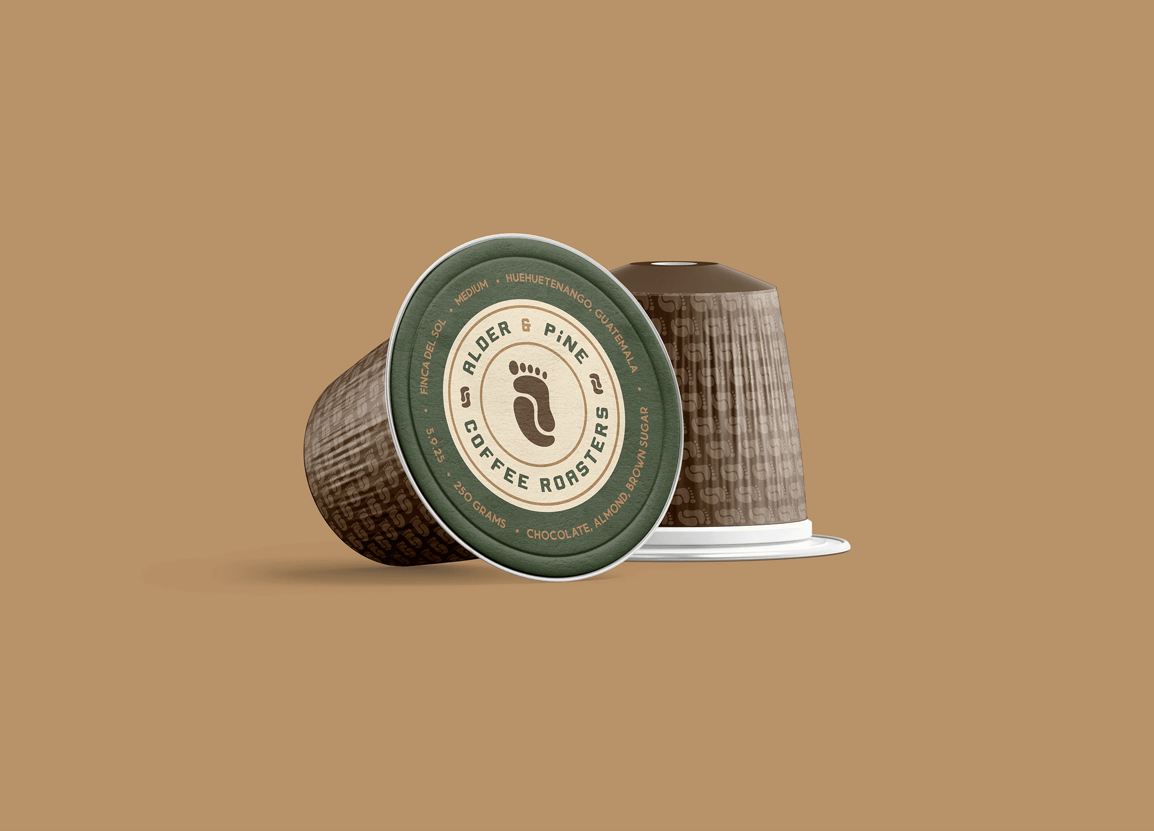 Graphic design mockup of a coffee single use cup for Alder & Pine Coffee Roasters — modern, clean wordmark and badge style logo of a footprint and a coffee bean with a bold decorative sans serif typography, designed by Will Lefkovich.