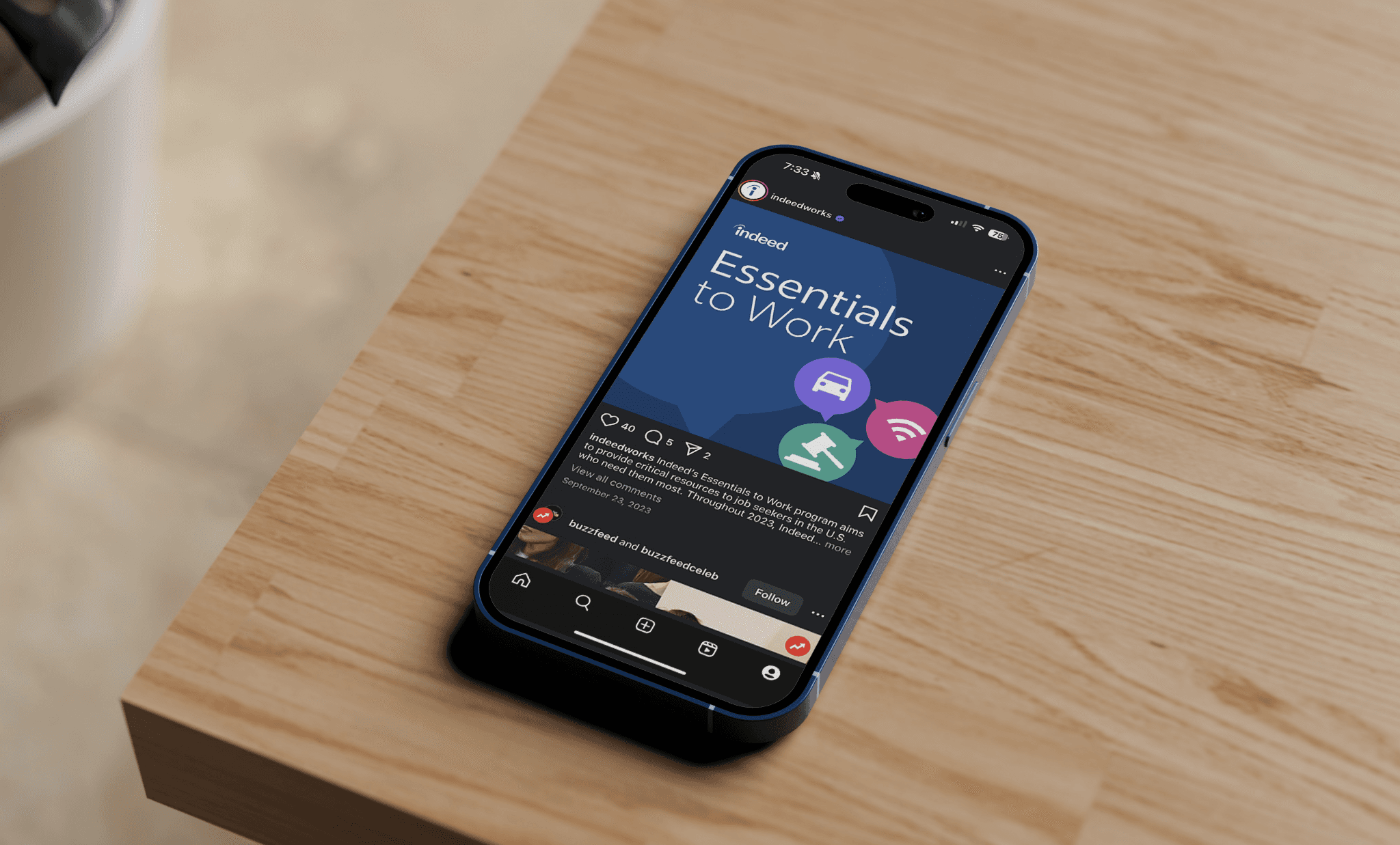 Indeed Essentials to Work Instagram post on a mobile phone atop a light wood table top