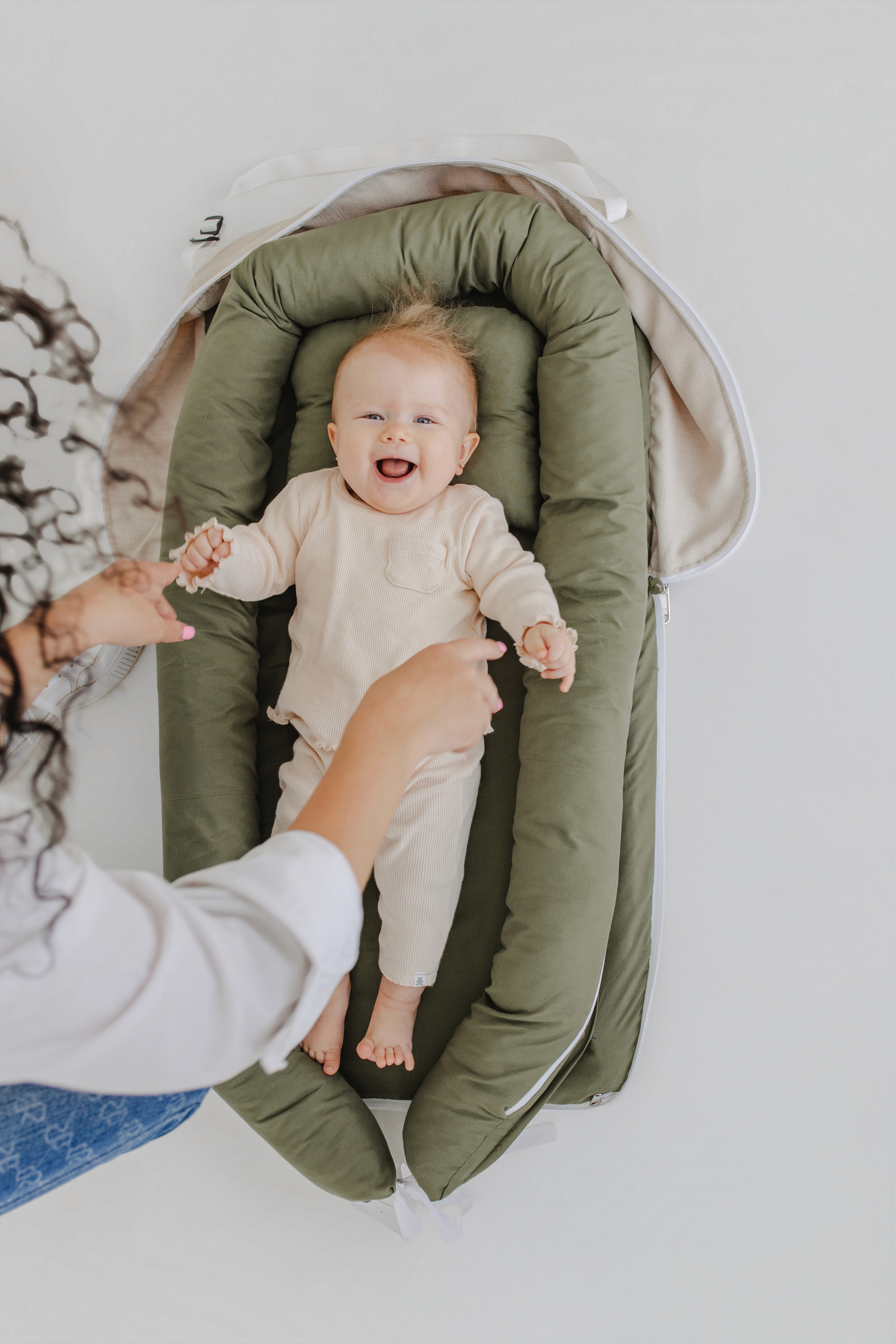 A bride and groom share a kiss surrounded by a joyful bridal party.