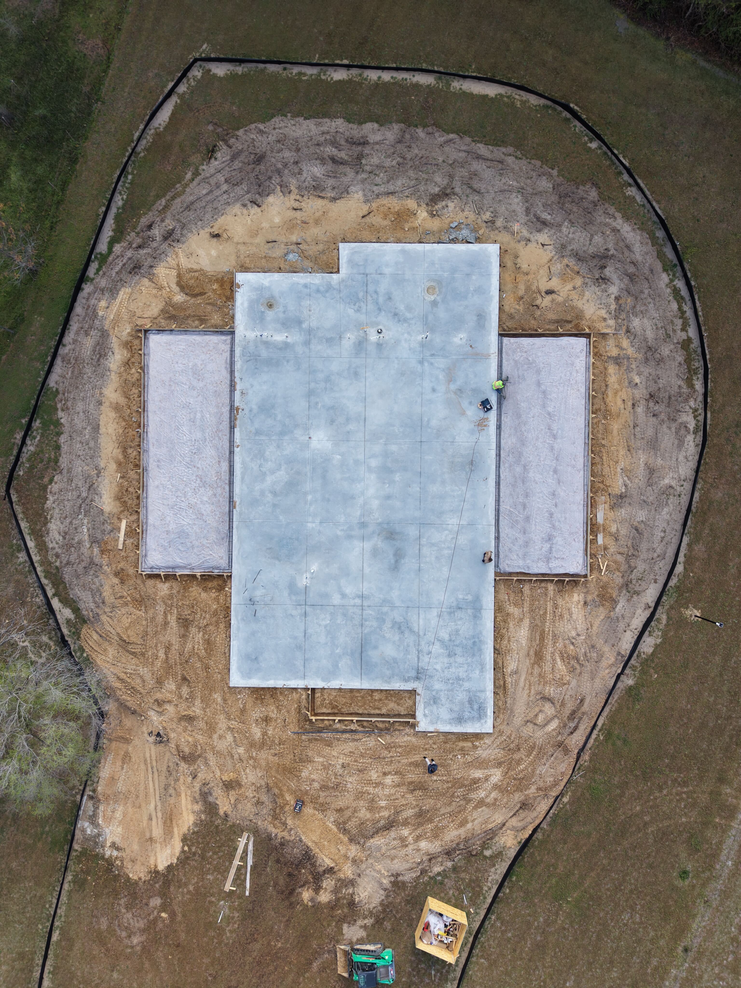 Aerial drone view of commercial building slab foundation with catio wings on an SEGC project