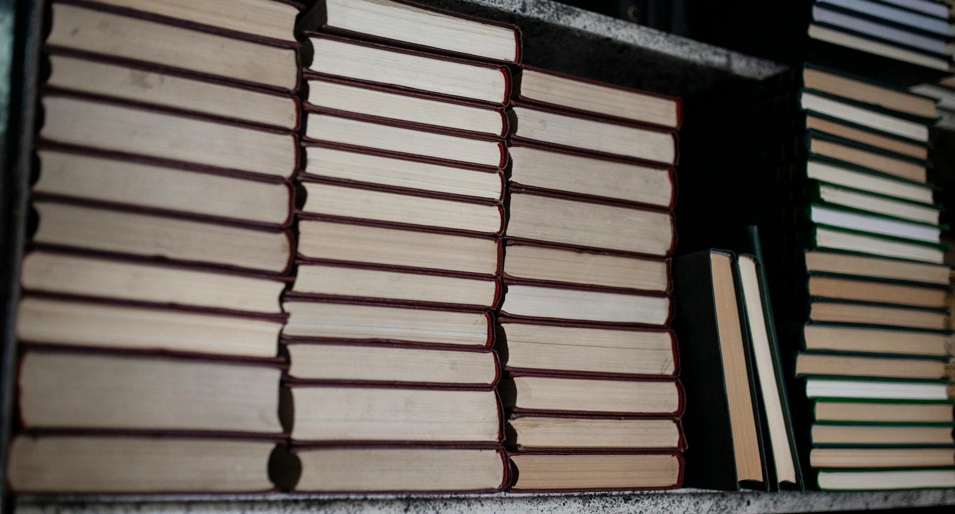 Group of older elementary students sitting at a wooden table highlighting complex vowel patterns in phonics books.
