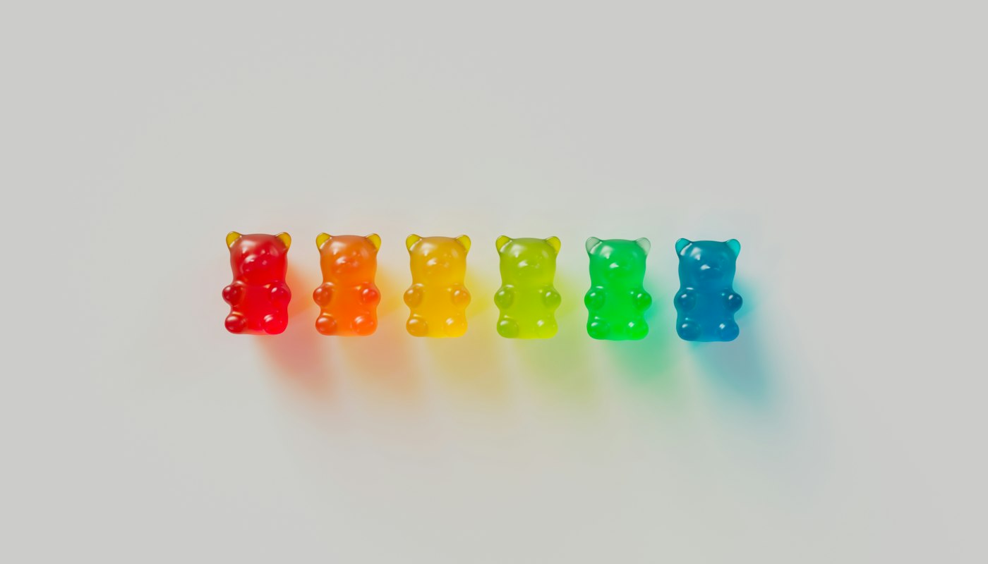 A row of gummy bears in rainbow colours