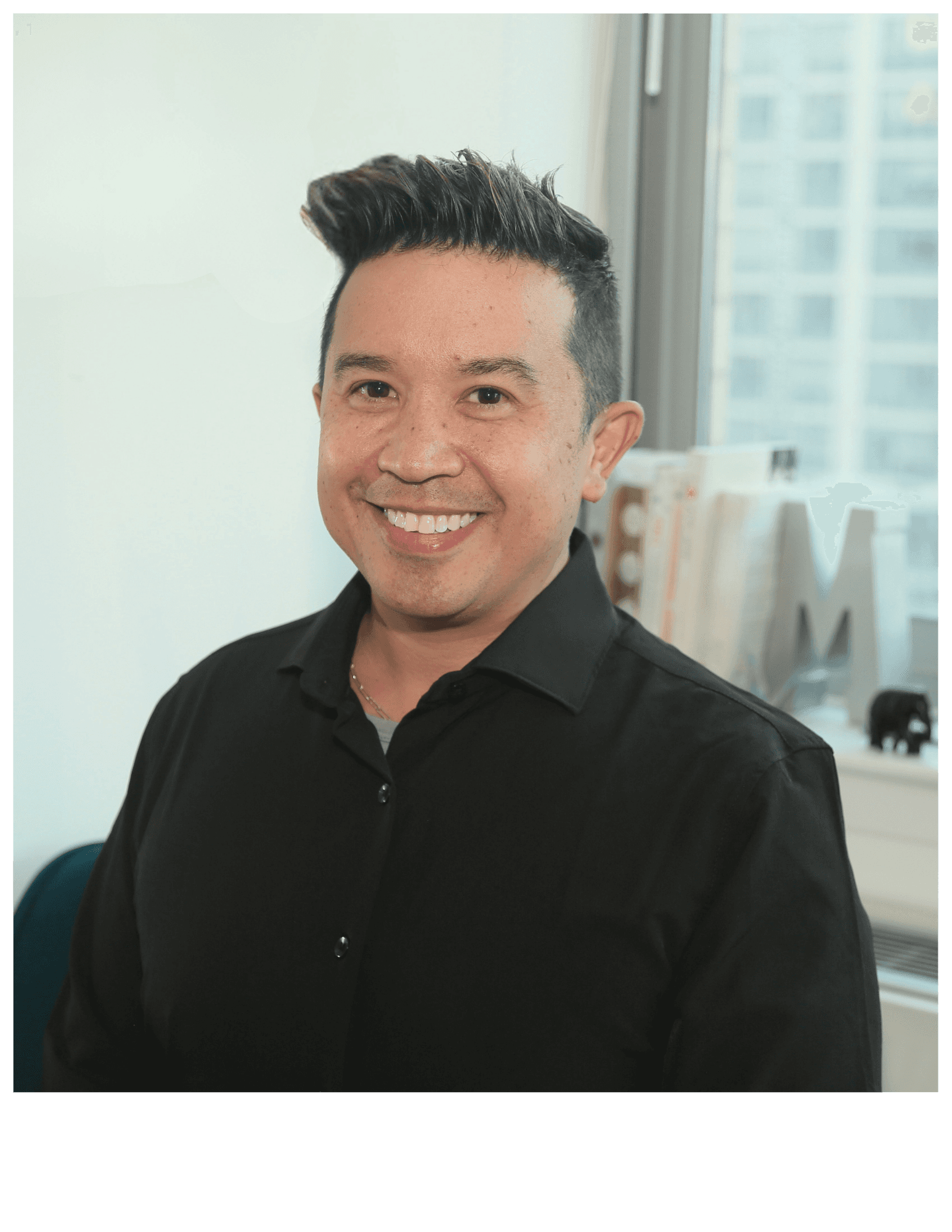Professional headshot of a business advisor in a white shirt, smiling confidently against a warm neutral background.