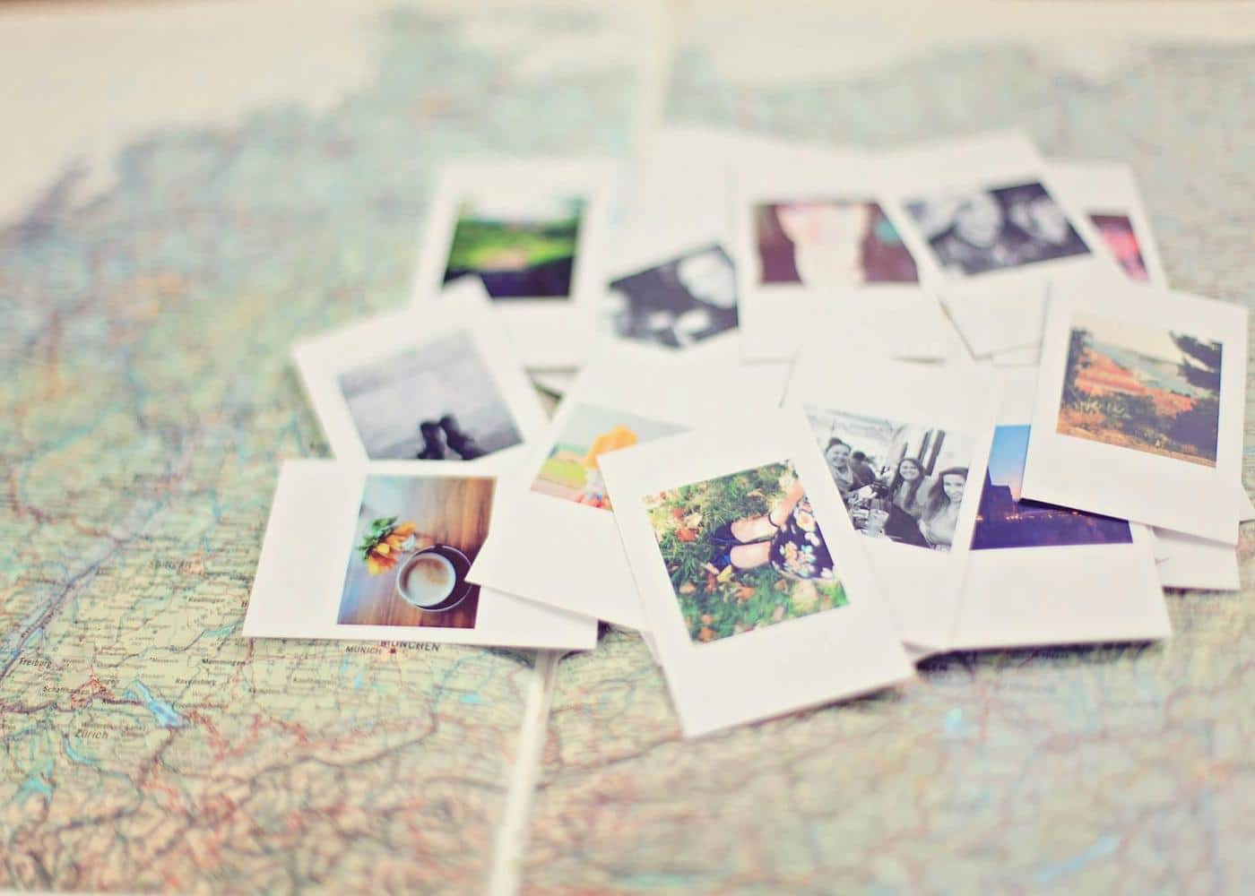 Polaroid pictures scattered on a map