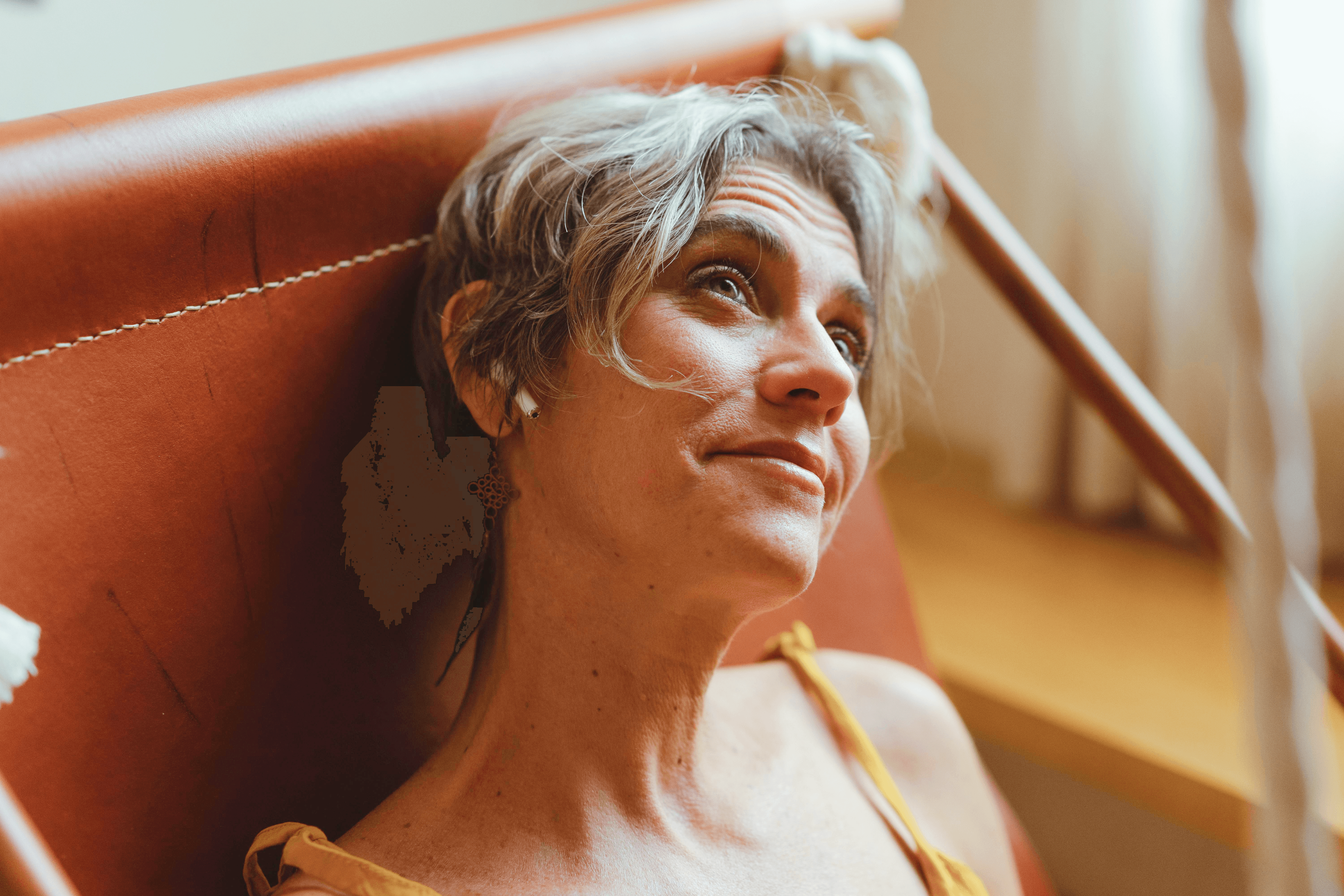 Close-up of a dark green leaf showing its textured surface and central vein against a muted background.