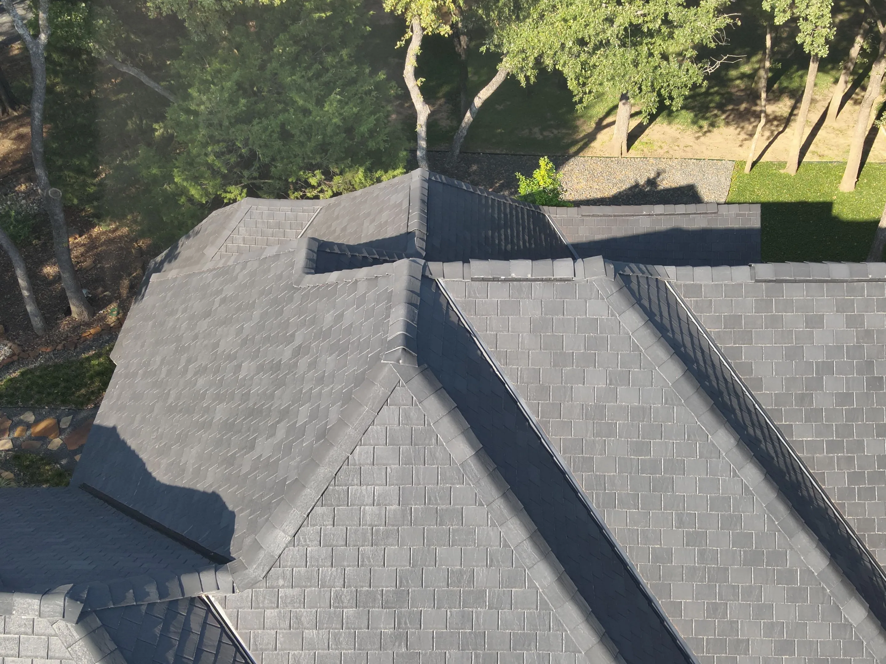 Close-up detail of F-Wave synthetic shingles showing authentic wood shake texture and premium quality materials on Corinth Texas home