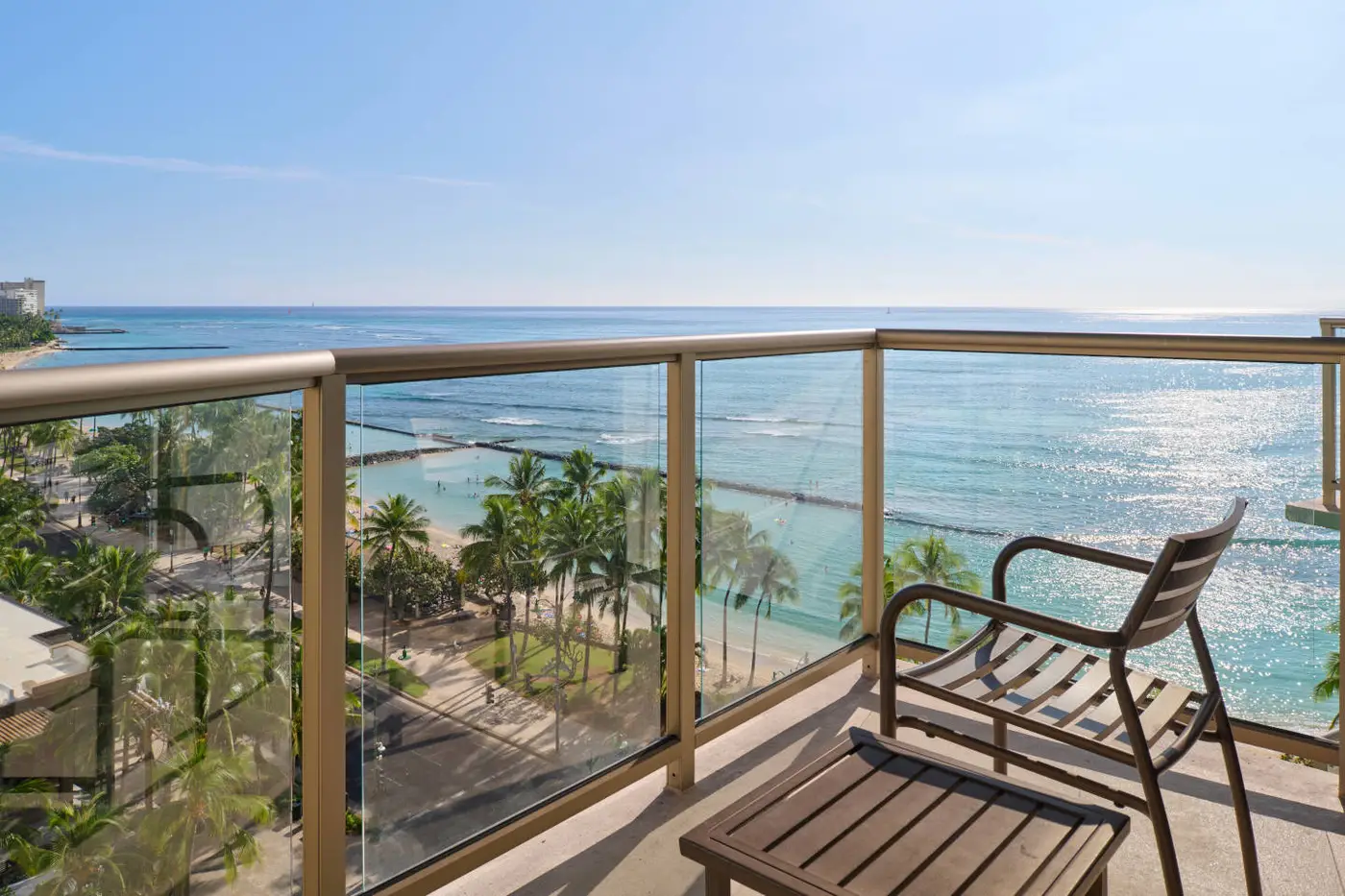 ocean view balcony with a chair overlooking the waikiki beach