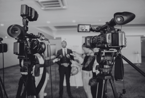 a video camera recording a man in a suit