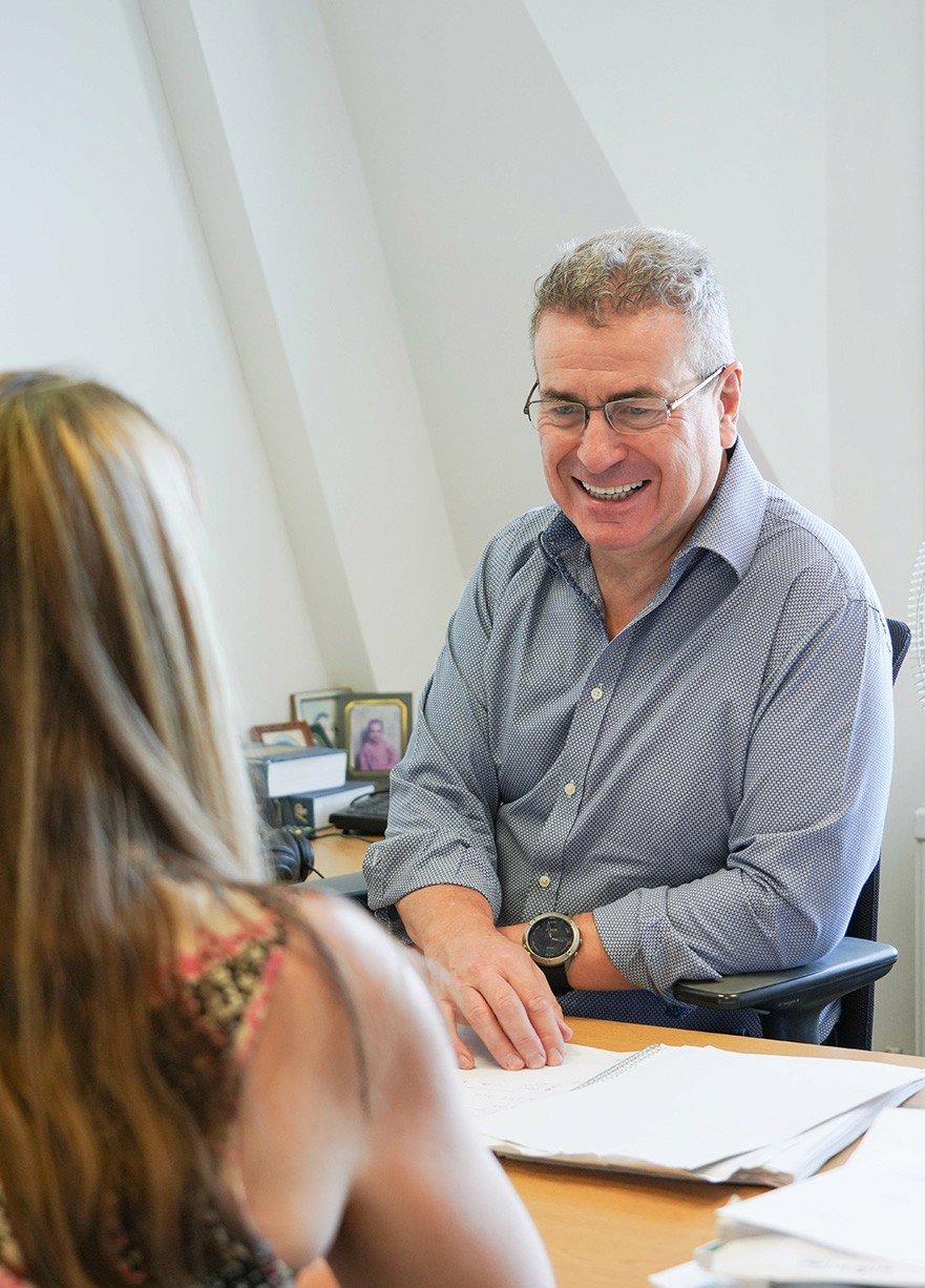 Hughes Price Walker investment team discussing pension scheme strategies during a client meeting.