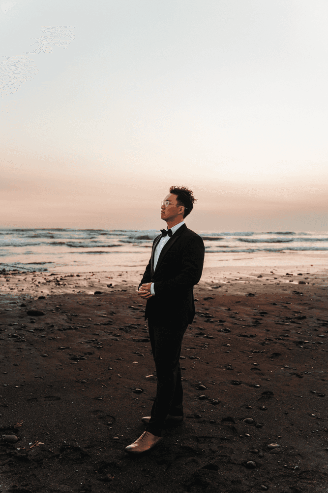 Full moon rising over a dark, silhouetted mountain ridge.