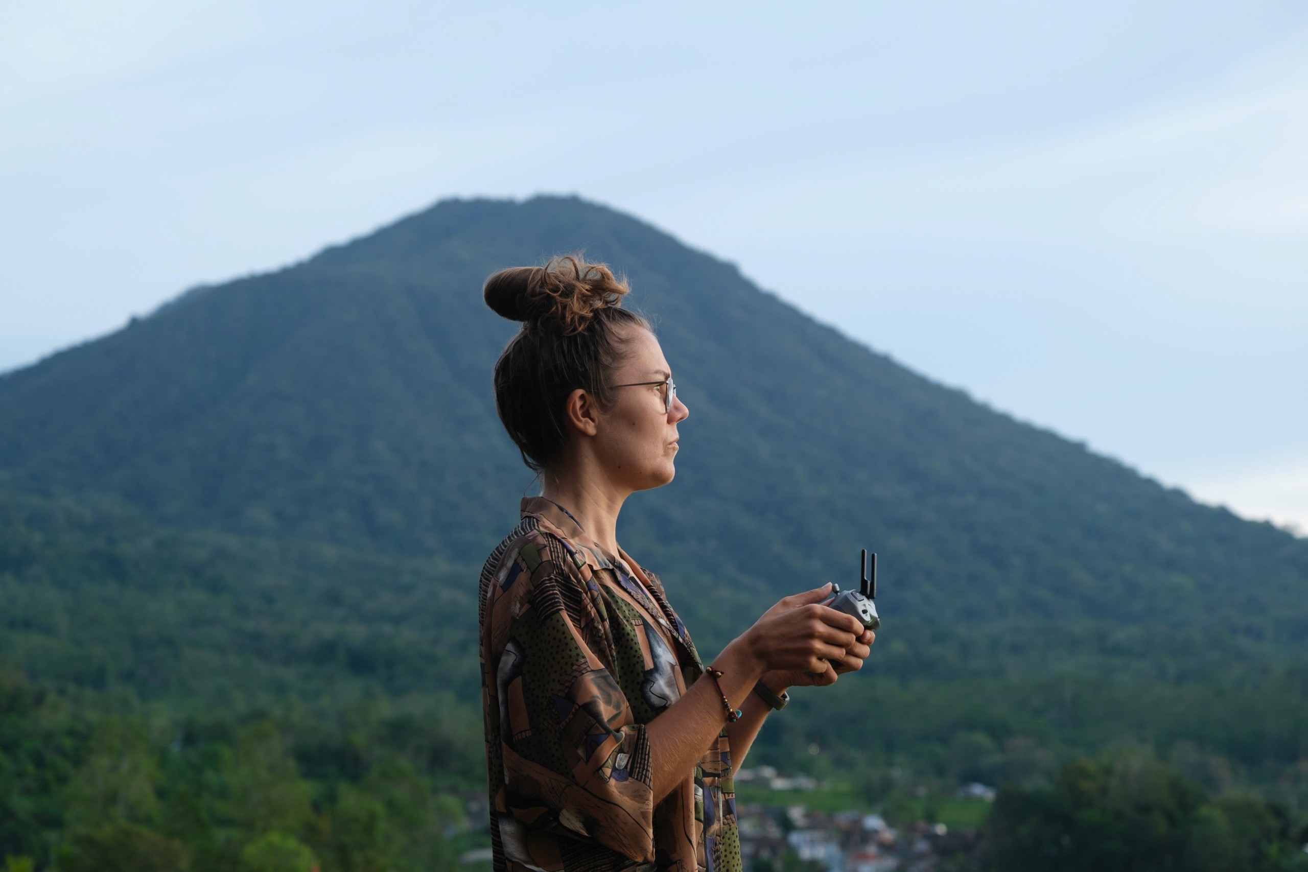 eva overlooking a lush tropical landscape during a mindful travel experience.