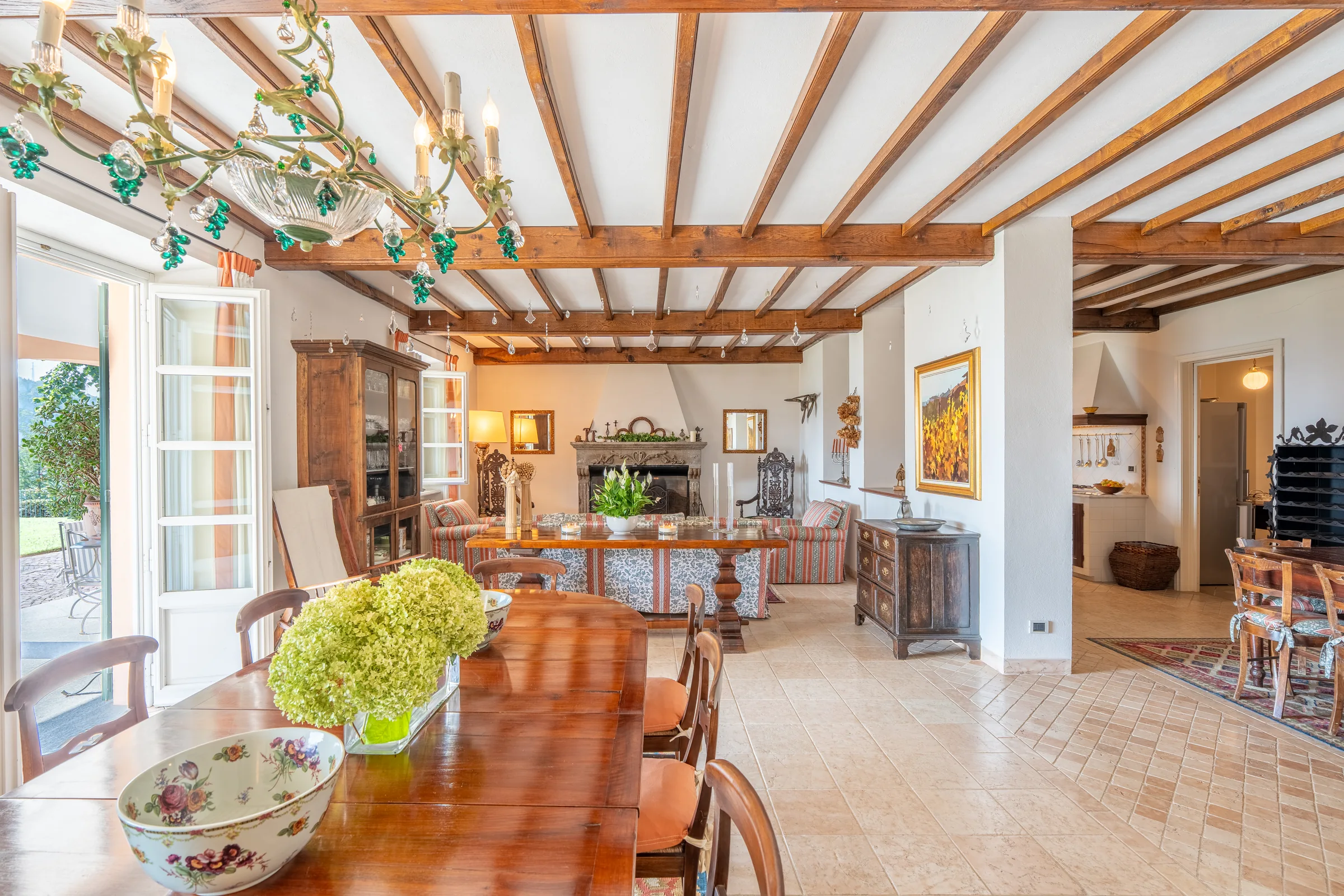 Living and dining room with timber beams — Villa Ceva, Italy. Photography by Yunes Calore.