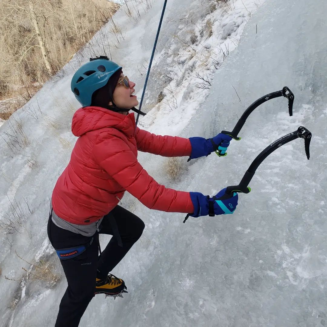 Ice climber in red looks ahead in lake city ice park