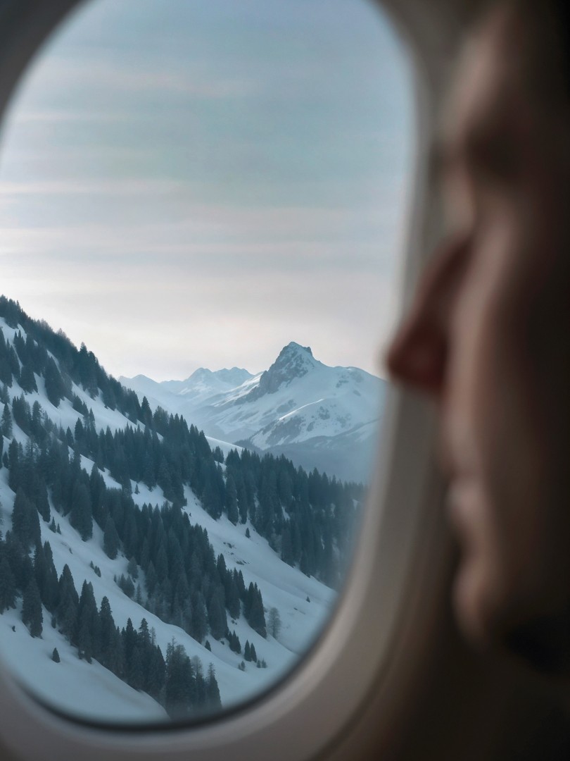 View of snowy mountains from an airplane window