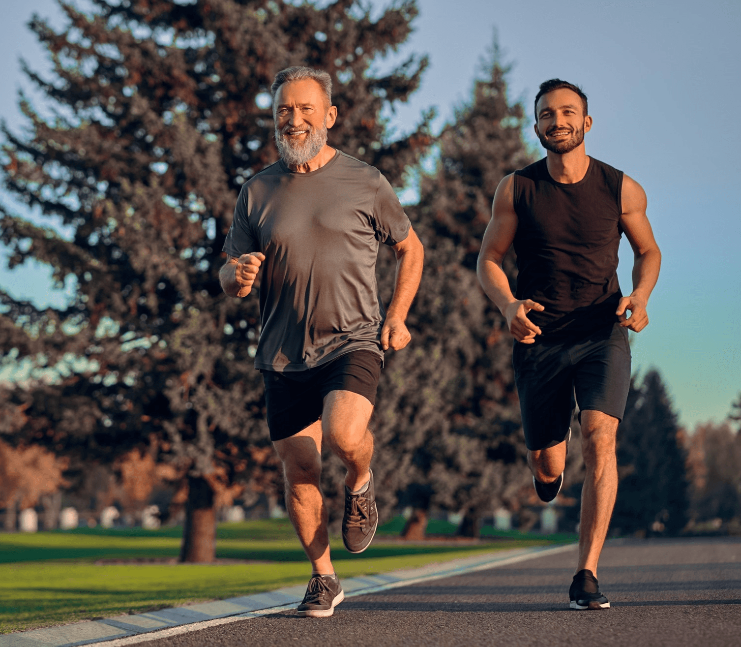 A 50-year-old man and a 30-year-old man jogging outdoors, embodying vitality and longevity through Lumyn Health’s personalised optimisation approach.