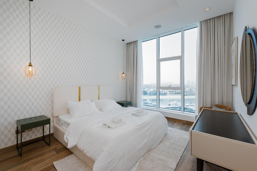 A cozy bedroom with a large bed and a window, highlighting the stylish interior of Oceana Residences.