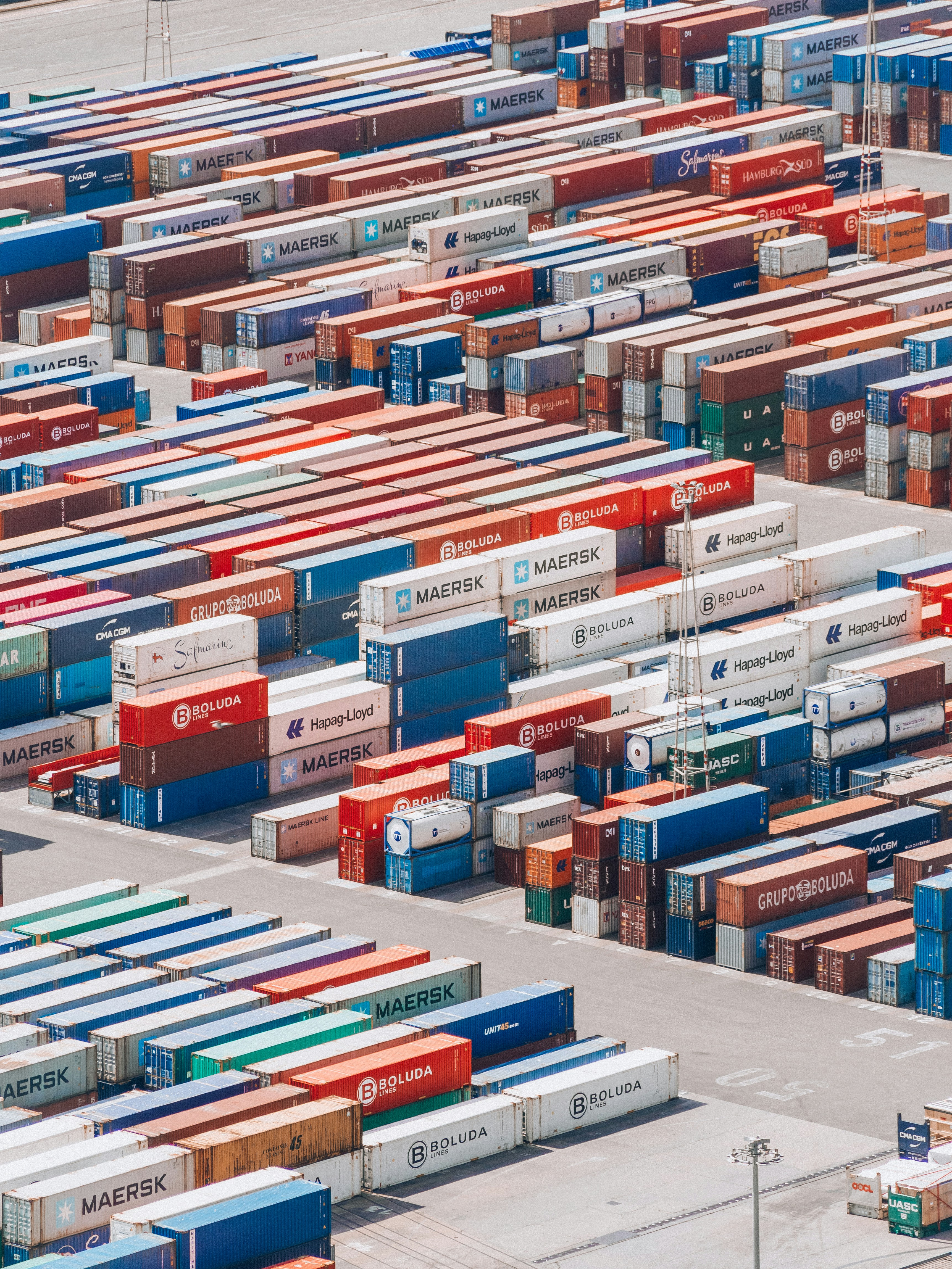 a large group of shipping containers are stacked together