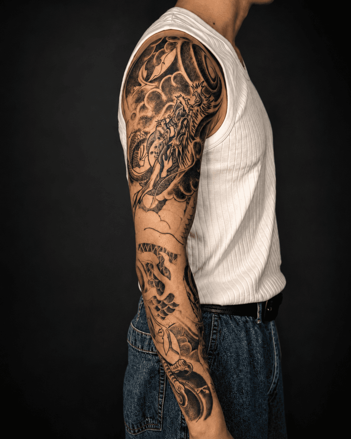 Tattoo artist working on a client’s arm in studio