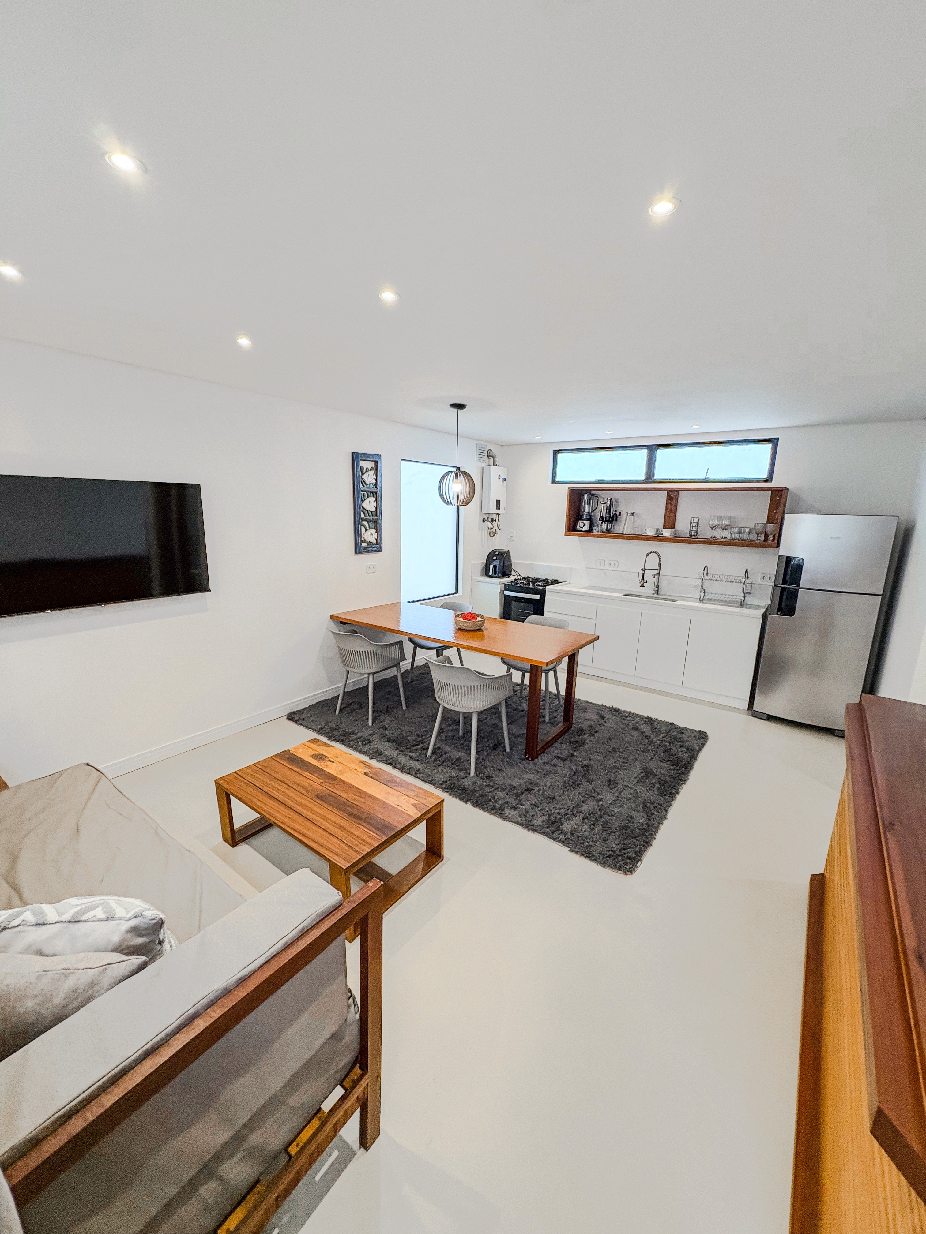 A serene garden-view hotel suite with private patio surrounded by tropical plants