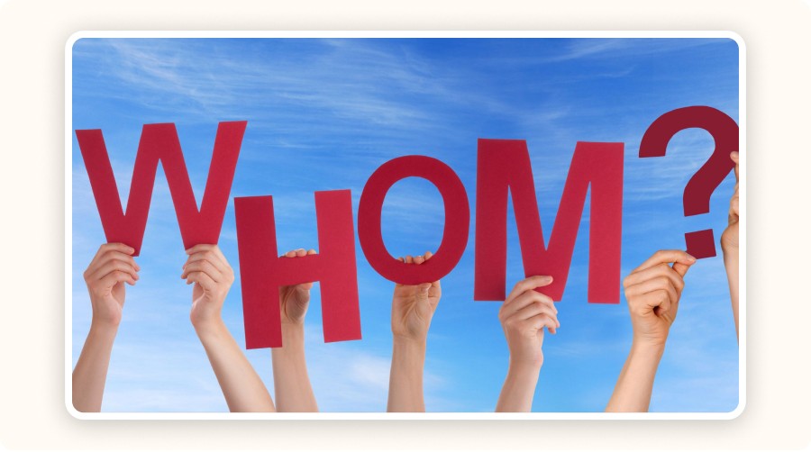 hands holding WHOM letters