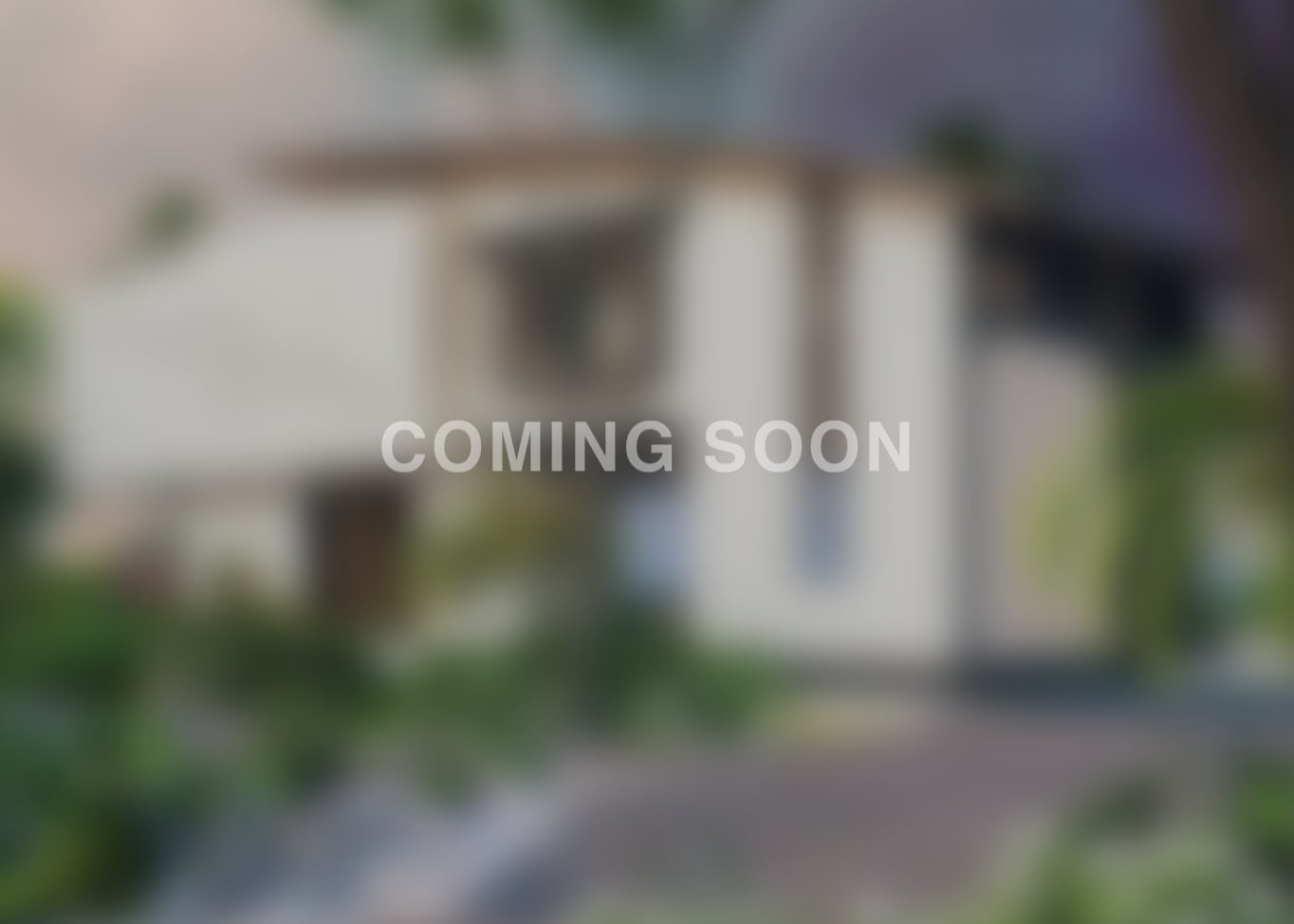 High angle looking down from sleeping loft, showing work desk below, floor-to-ceiling windows and soft sunset hues