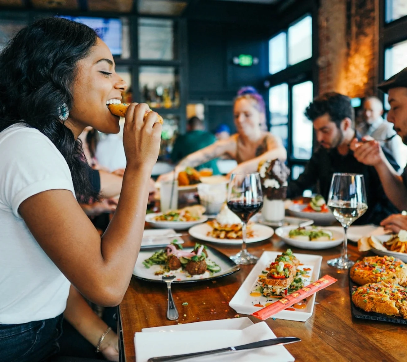 Restaurant guest dining with other customers in the background