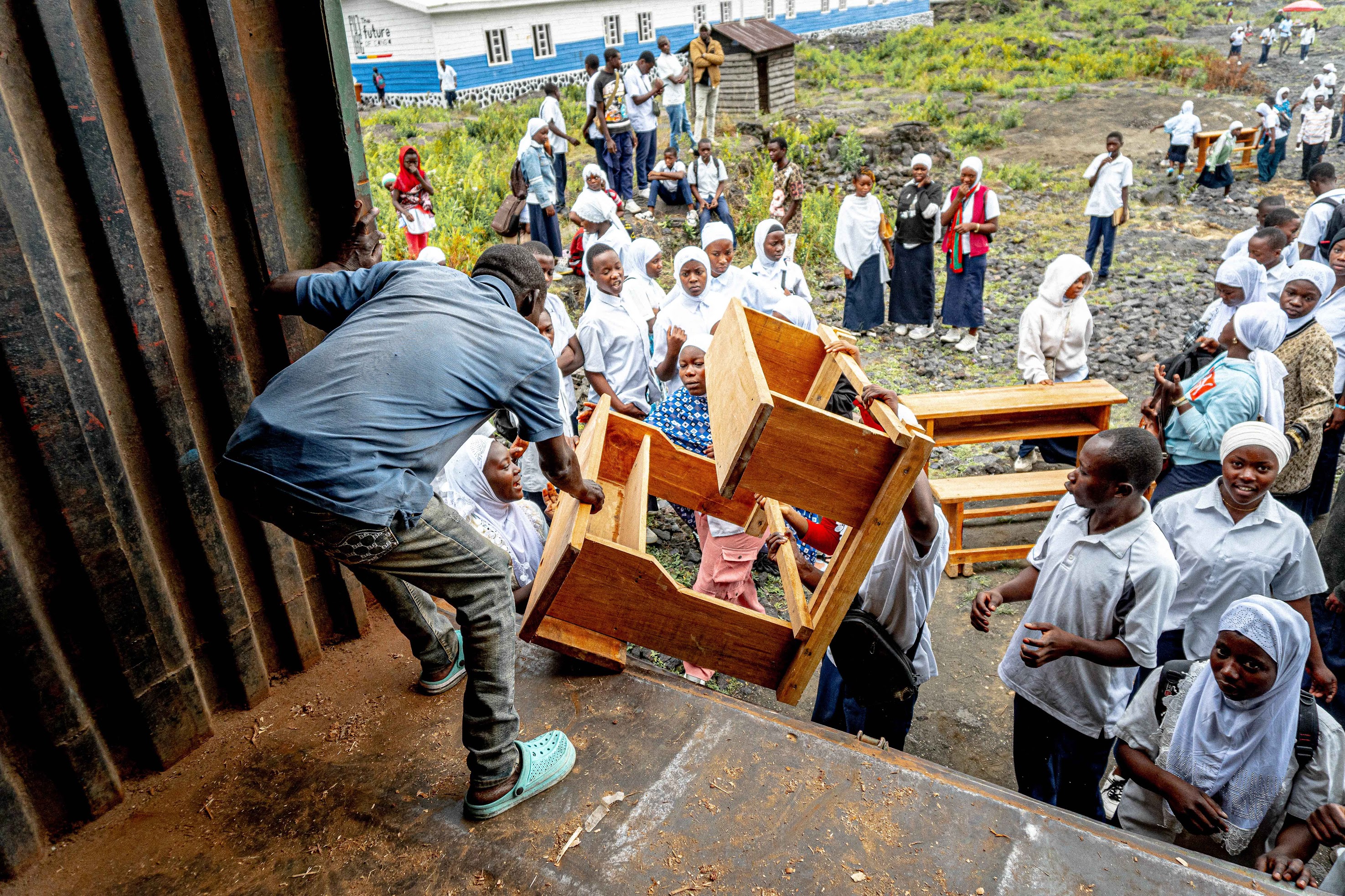 a young boy smiling in front of a group of people