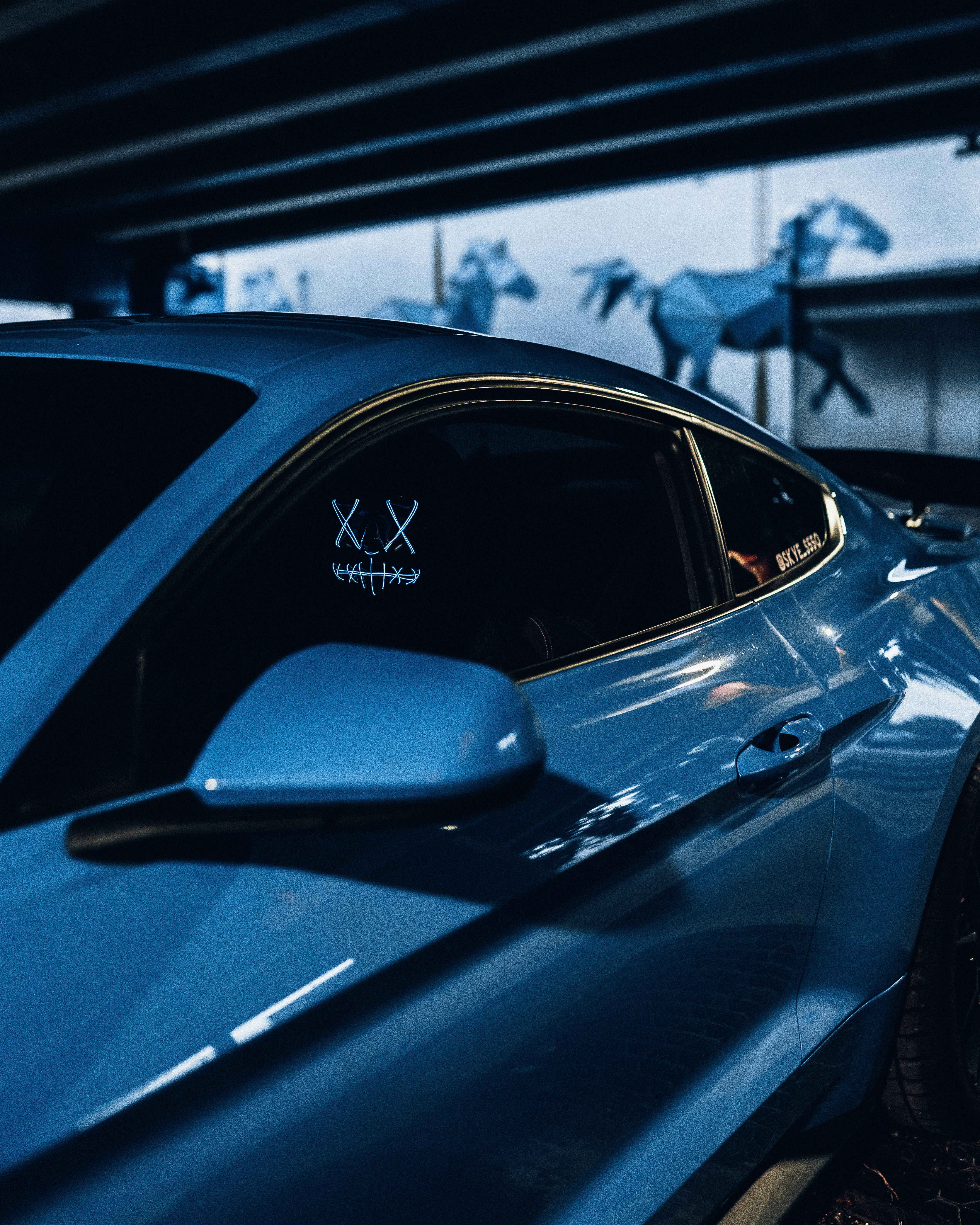 blue car parked in garage