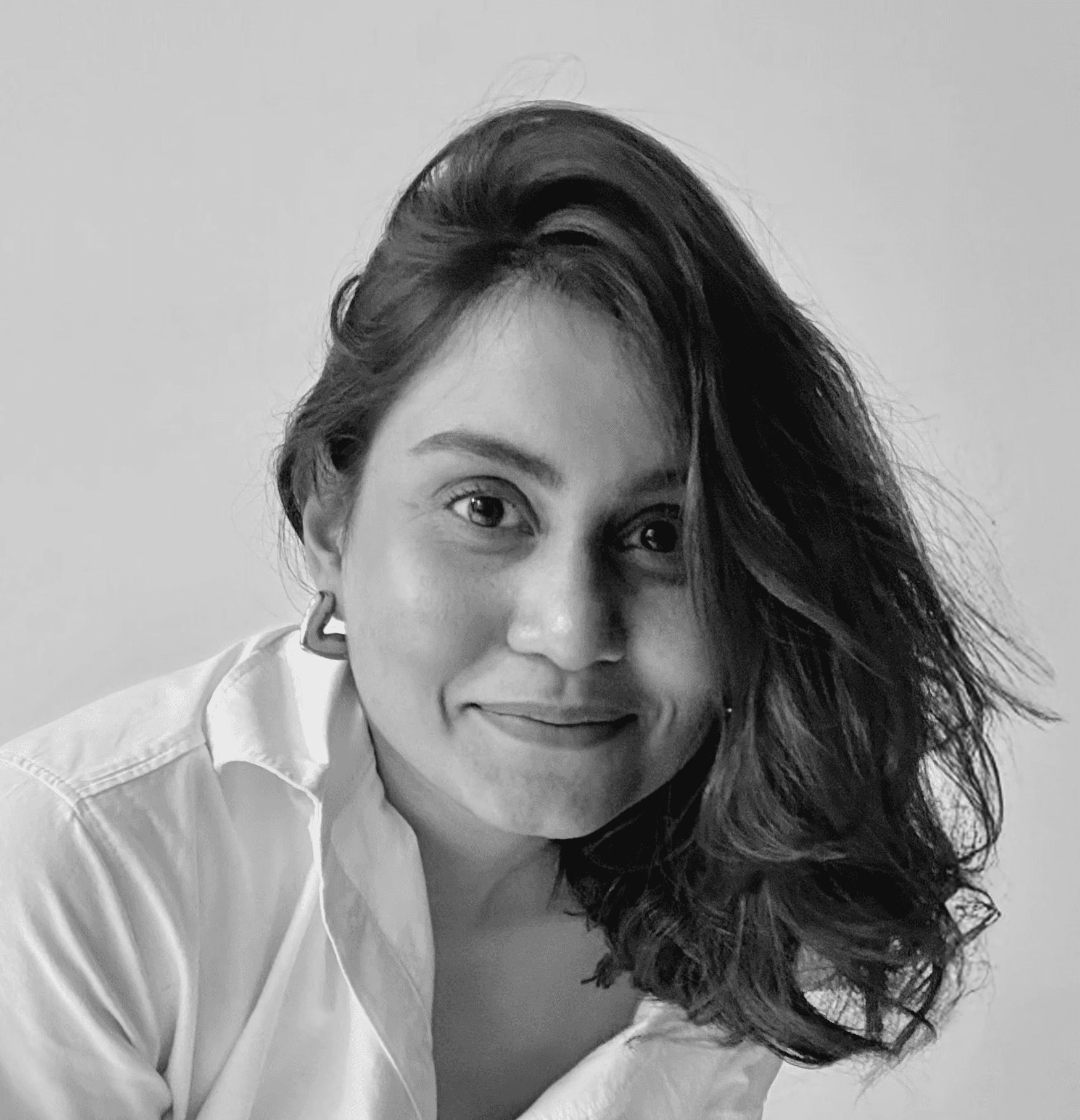 Woman working at desk with laptop and phone.
