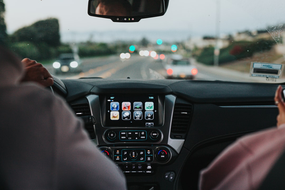 person driving car on road during daytime