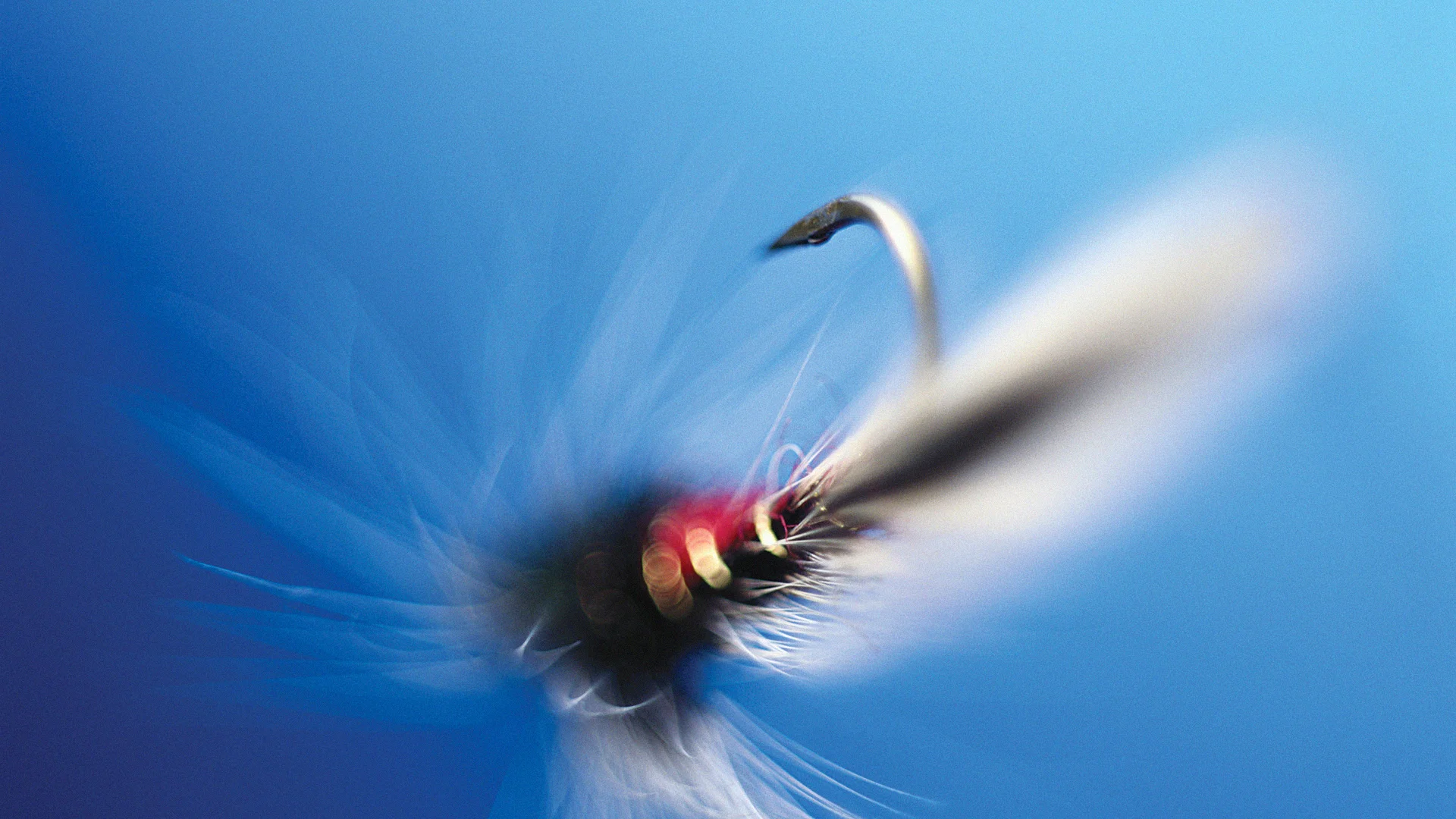 A fishing lure casting out into blue water