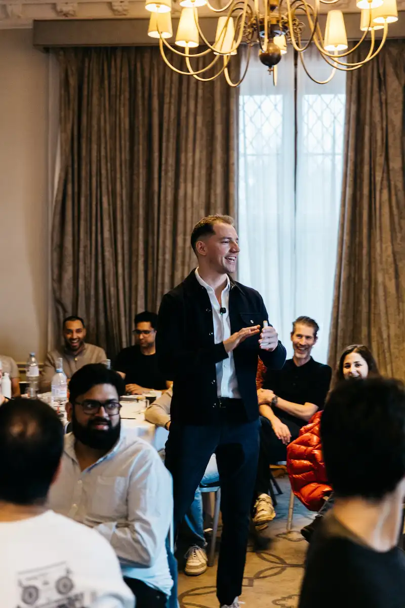 Man in black jacket speaking to audience