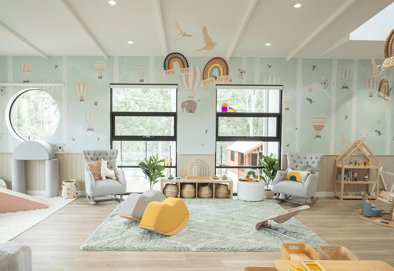 girl in green jacket playing with white and pink plastic balls on green grass field during