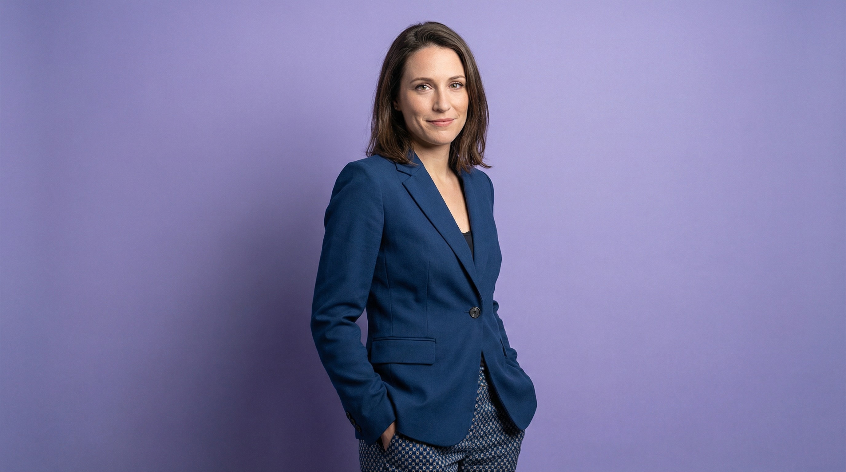 Close-up of lush, dark green leaves, some glossy and wet, against a muted background.