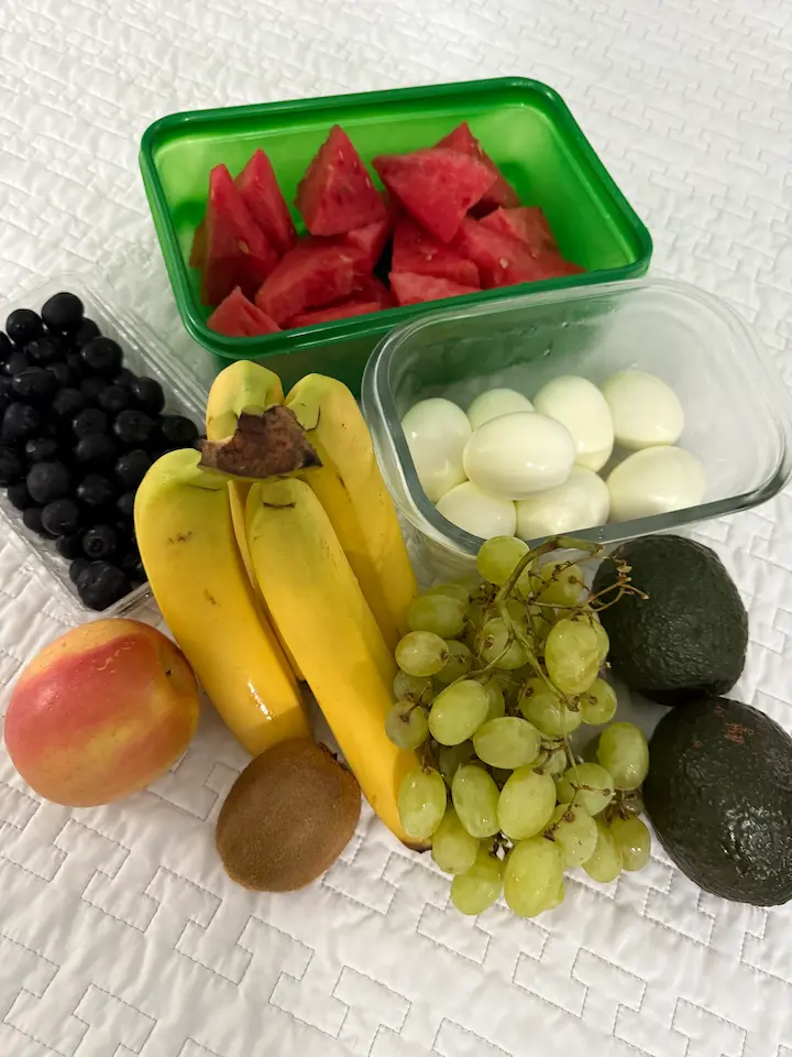 Cut kiwi, blueberries, grapes, apples, and watermelon in containers, prepped for the week.
