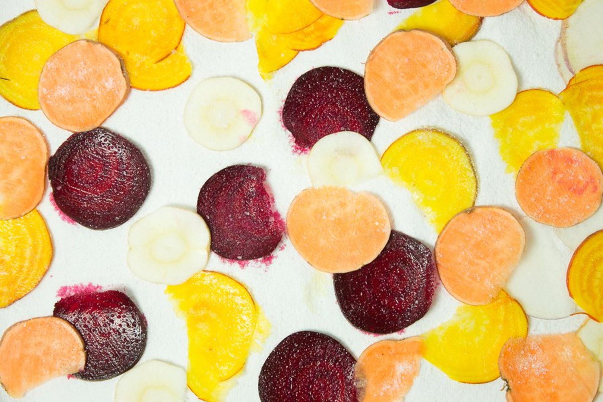 sliced ingredients for the mixed veggie chips on a baking sheet