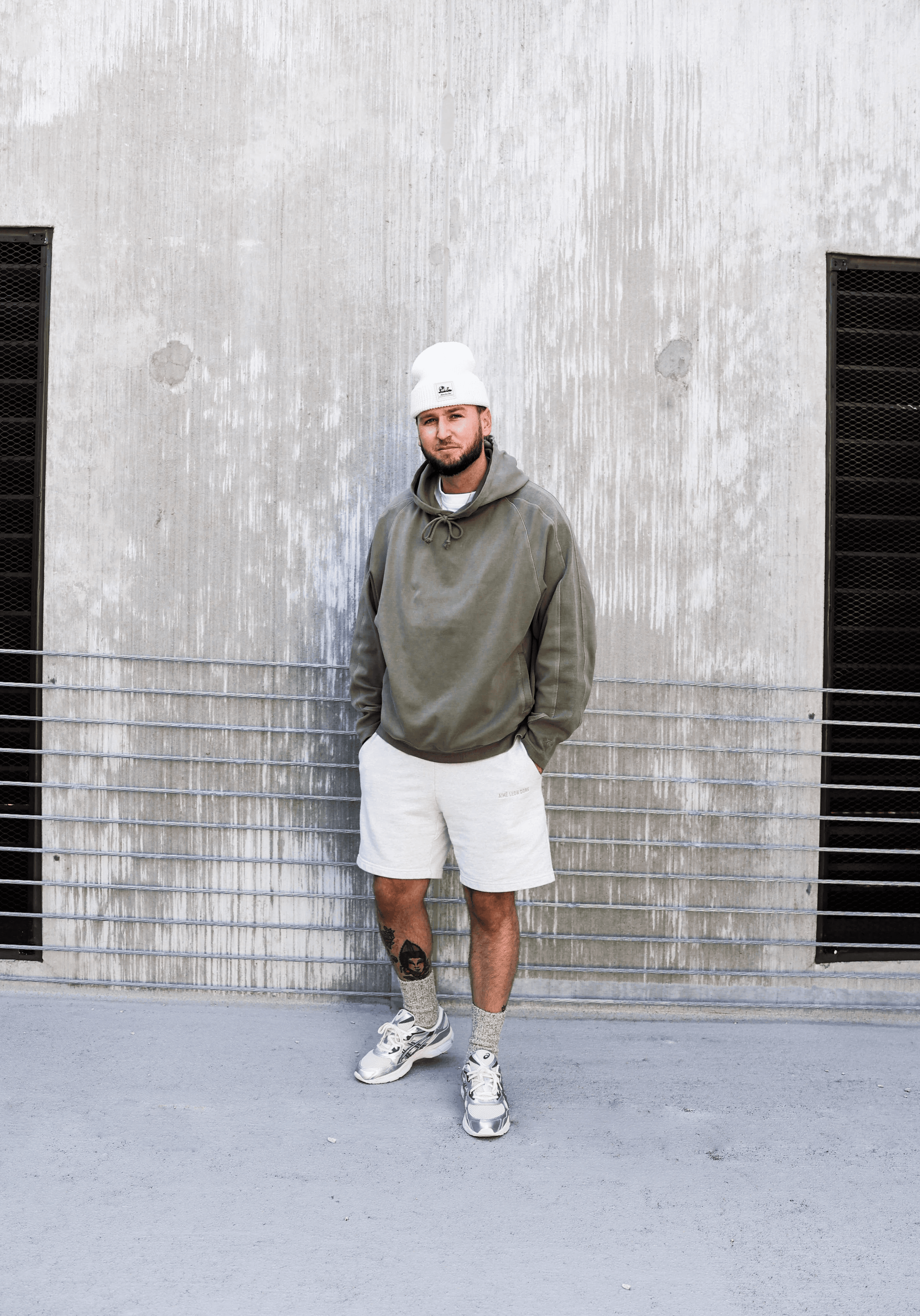 Black and white portrait of a smiling person with curly hair