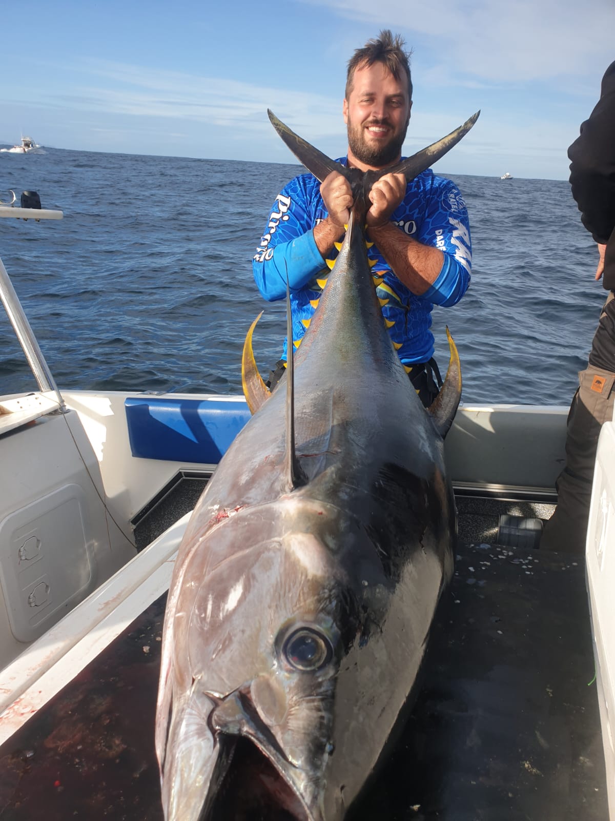 Fishermen celebrating a successful catch on a Salt Safari charter.