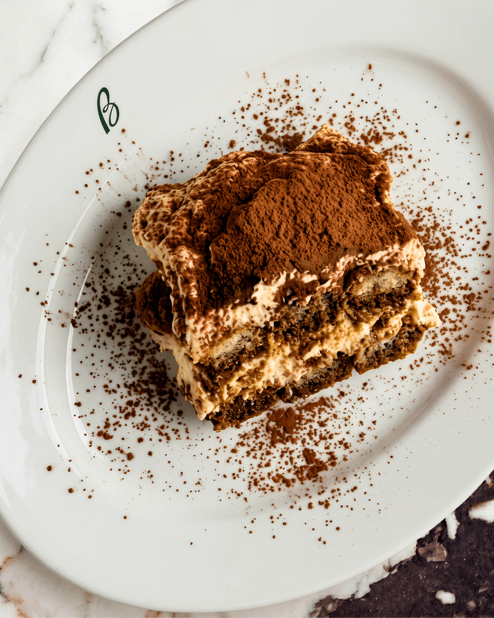 Slice of tiramisu dusted with cocoa powder