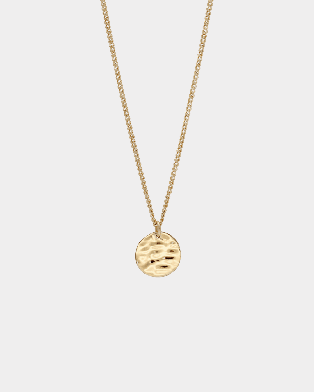 close up detail of back of gold pendant