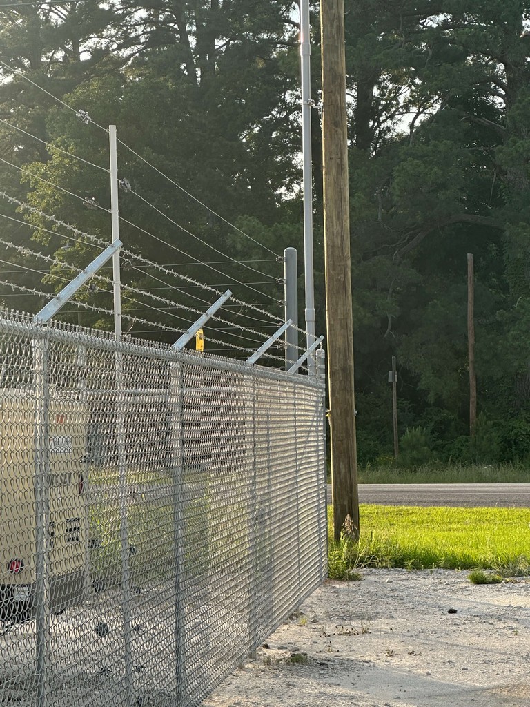 This picture shows a security fence with razor wire at the top that we can install around properties.  We also run security fencing from our welding and fabrication shop in Henderson, Texas.