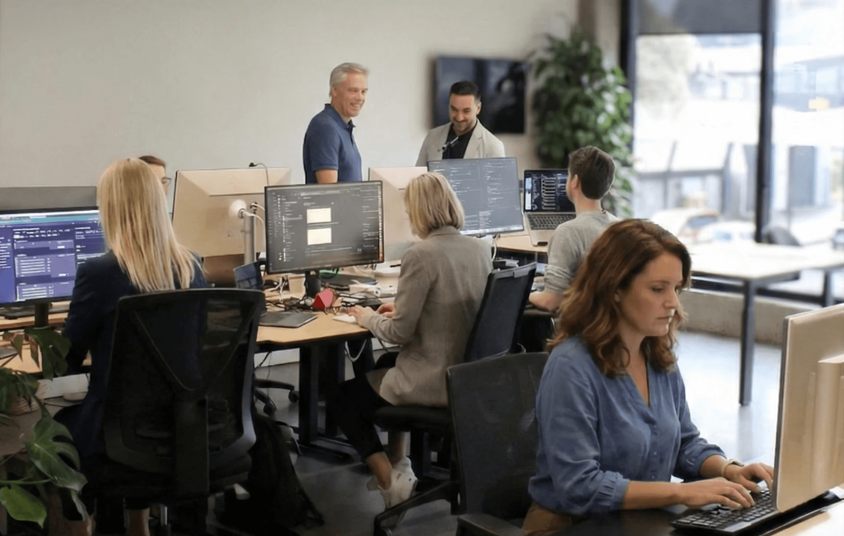 Product and engineering team collaborating on custom portal development in a modern workspace