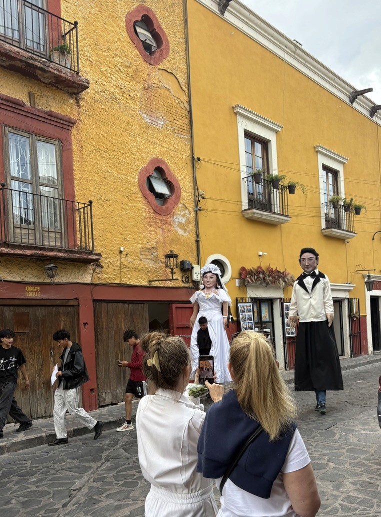 Traditional figures on a historic San Miguel street