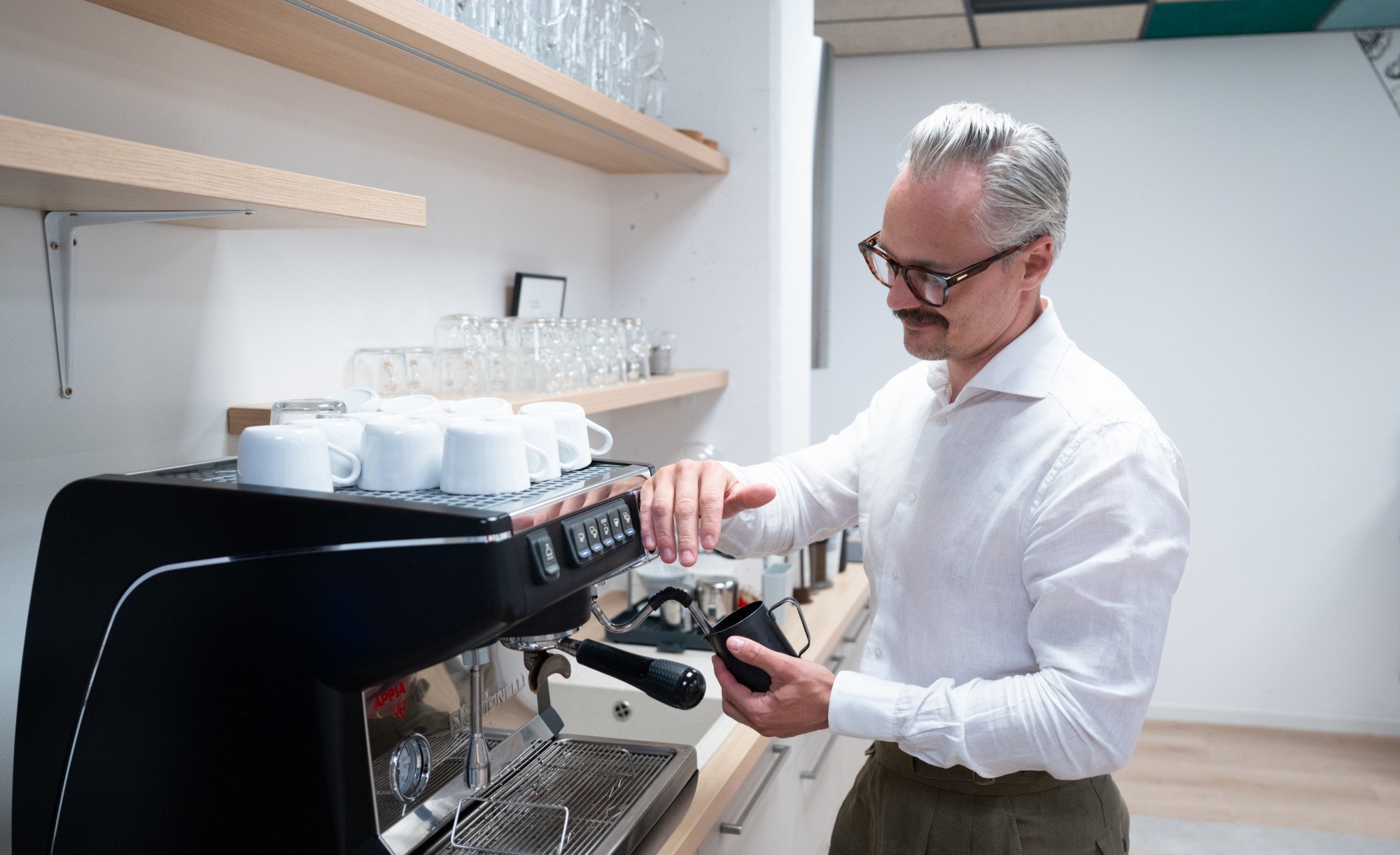 Lukáš Rychtecký making coffee at an espresso machine