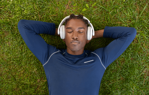 a man wearing headphones standing in a field