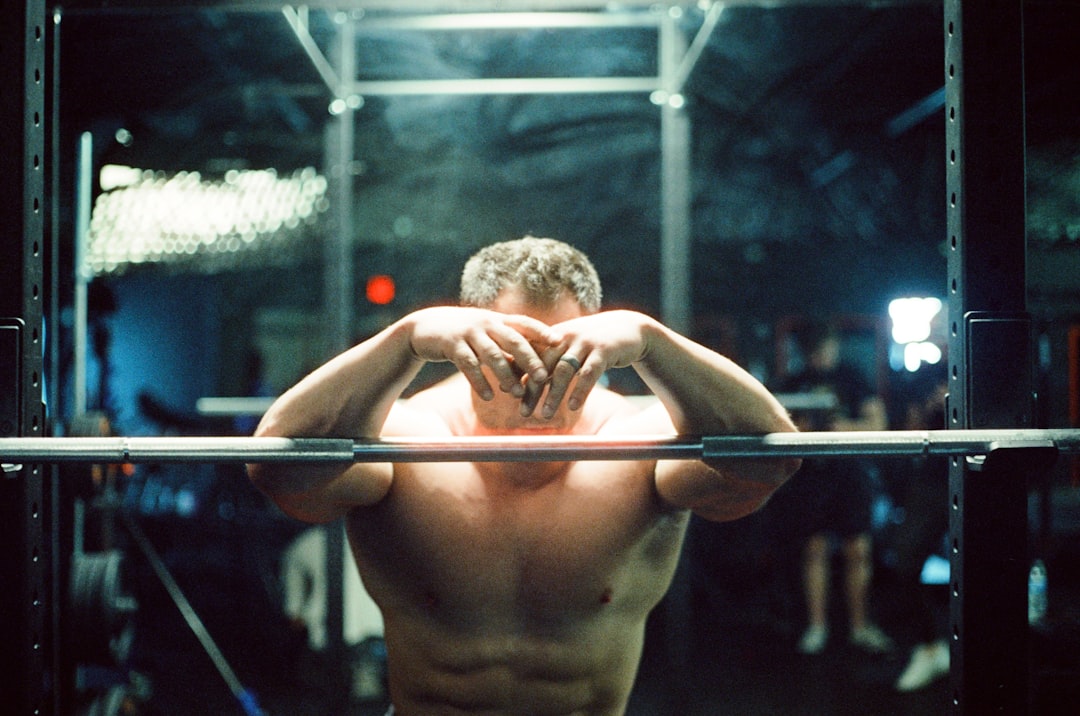 A dramatic training cage scene where the intense lighting and athlete's commitment are enhanced as the image becomes colorful during interaction.