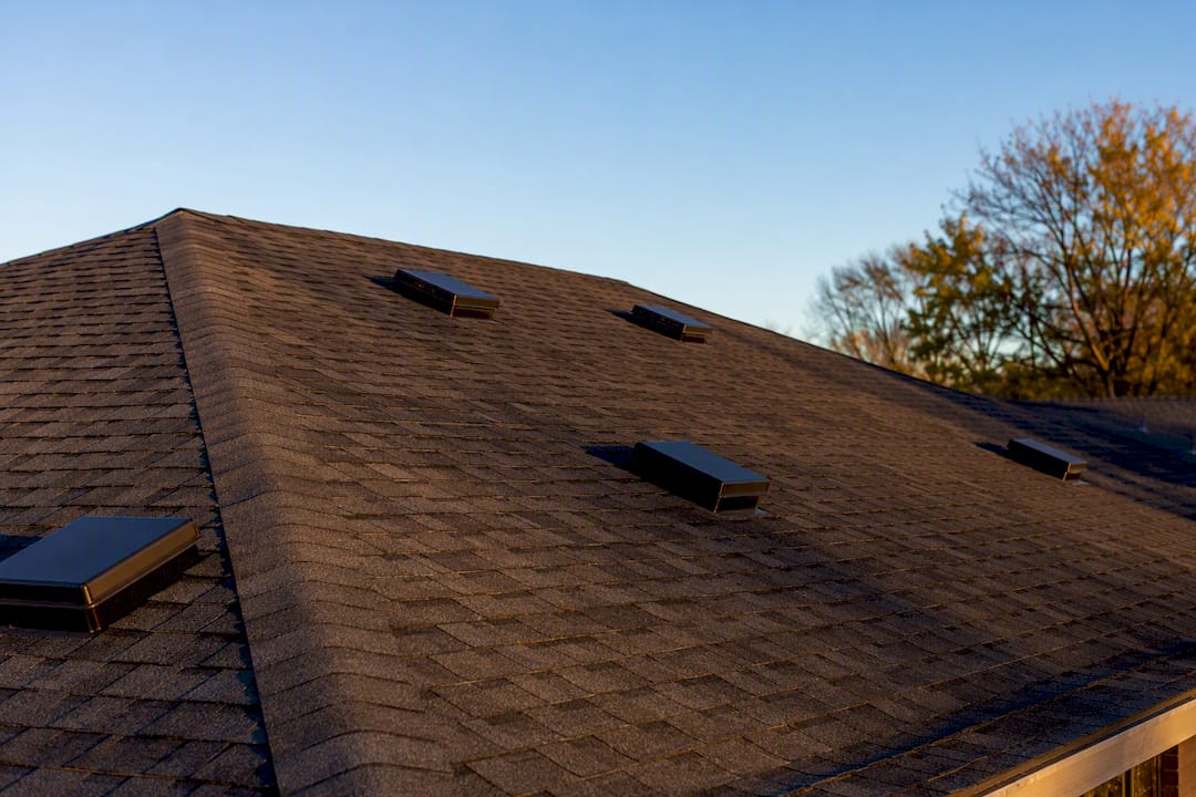 Static box vents spaced on hip roof